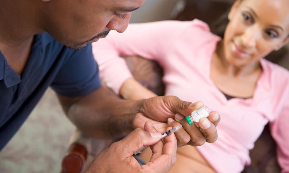 Fertility shots for men and women — woman preparing to receive fertility shot