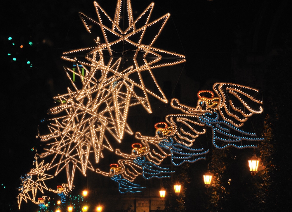 A Christmas street display of illuminated stars and angels in a row, possibly decorating one of the many holiday events in Hurst.